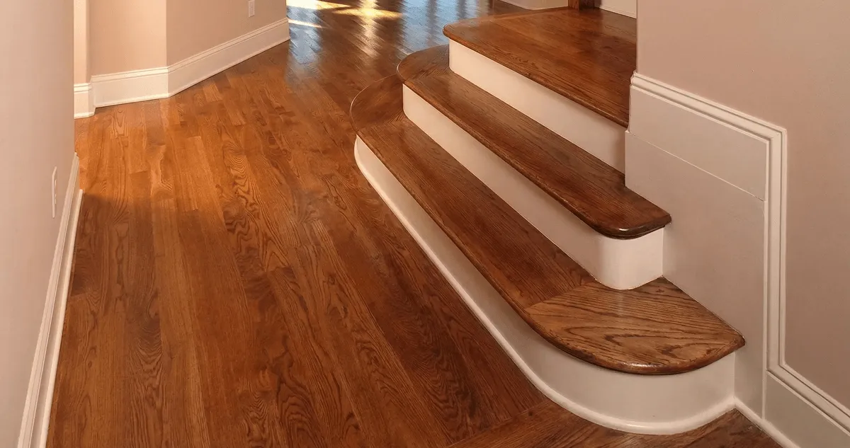 Base floor of a staircase with professionally restored wood flooring in Indianapolis IN
