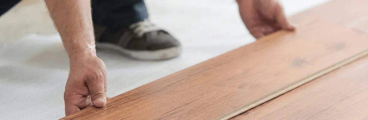 A professional installing laminate flooring in Indianapolis, IN