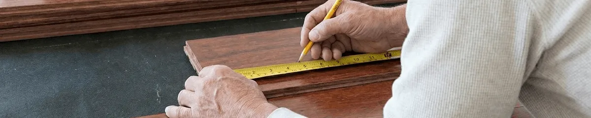 A professional installing wood flooring in Indianapolis, IN